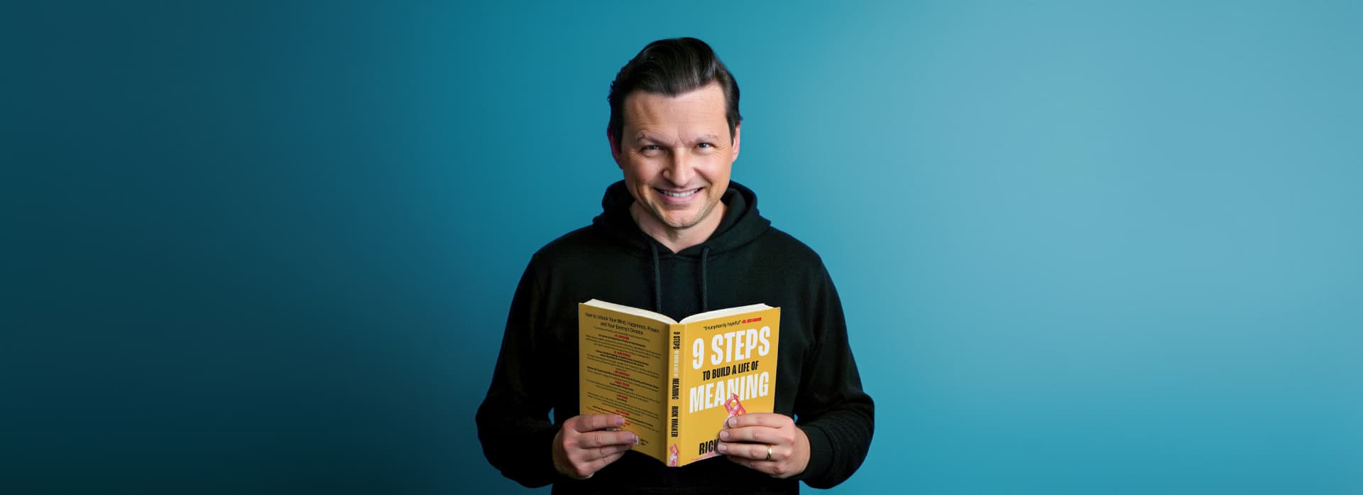 Rick Walker holding his book, 9 Steps to Build a Life of Meaning