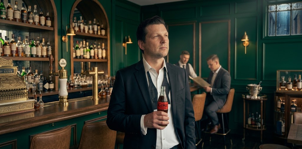 Rick Walker in a wood and green paneled bar